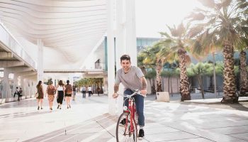 happy-young-man-riding-bicycle-pavement